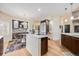 Charming kitchen with decorative backsplash, stainless steel appliances, and an adjacent breakfast nook with colorful rug at 6500 W Mansfield Ave # 39, Denver, CO 80235
