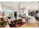 Spacious living room featuring an open floor plan, a fireplace, and seamless flow to the kitchen and dining areas at 6500 W Mansfield Ave # 39, Denver, CO 80235