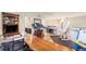 Bright room featuring a treadmill, built-in shelving, and an easel at 6500 W Mansfield Ave # 39, Denver, CO 80235