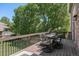 Outdoor patio with comfortable seating, table and natural light from large trees offers serene atmosphere at 6500 W Mansfield Ave # 39, Denver, CO 80235