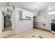 Small basement kitchenette with tile floor,cabinets, and appliances at 3230 S Bannock St, Englewood, CO 80110