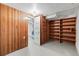 Unfinished basement with wood paneling and shelving at 3230 S Bannock St, Englewood, CO 80110