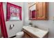 Clean bathroom with wood vanity and window at 3230 S Bannock St, Englewood, CO 80110