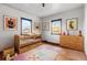 bedroom with crib and wood dresser at 3230 S Bannock St, Englewood, CO 80110