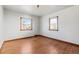 Empty bedroom featuring hardwood floors and two windows at 3230 S Bannock St, Englewood, CO 80110