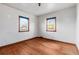 Empty bedroom with hardwood floors and two windows at 3230 S Bannock St, Englewood, CO 80110