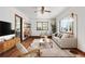 Living room with hardwood floors, staged furniture, and bookshelf at 3230 S Bannock St, Englewood, CO 80110