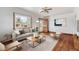 Living room with hardwood floors and staged furniture at 3230 S Bannock St, Englewood, CO 80110