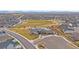 Aerial view of a community park with a playground, splash pad, pool, clubhouse and a large central green space at 6335 E 143Rd Dr, Thornton, CO 80602