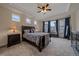 Beautiful primary bedroom with tray ceiling, plush carpet, and large windows at 6335 E 143Rd Dr, Thornton, CO 80602