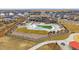 View of a community pool area with a splash pad, seating, shade structures, and landscaping within a fenced enclosure at 6335 E 143Rd Dr, Thornton, CO 80602