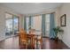 Dining room with hardwood floors, large windows, and a view of the backyard at 6335 E 143Rd Dr, Thornton, CO 80602