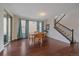 Bright dining room with hardwood floors, large windows, and a sliding glass door leading to the outside at 6335 E 143Rd Dr, Thornton, CO 80602