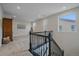 Upstairs hallway landing area with carpet and decorative railing at 6335 E 143Rd Dr, Thornton, CO 80602