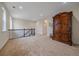 Upstairs hallway landing area with carpet and decorative railing at 6335 E 143Rd Dr, Thornton, CO 80602