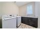 Laundry room with modern washer and dryer, complete with countertop and cabinet space at 6335 E 143Rd Dr, Thornton, CO 80602