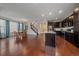 Open concept living room and kitchen area with hardwood floors and stainless steel appliances at 6335 E 143Rd Dr, Thornton, CO 80602