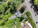 Picturesque aerial view of property shows lush greenery, detached garage, and proximity to the road at 1580 Youngfield St, Lakewood, CO 80215
