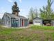 Backyard view shows a detached garage, shed, and lawn area, perfect for outdoor activities at 1580 Youngfield St, Lakewood, CO 80215