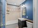 Bathroom with a shower-tub, vanity, and blue walls creates a cozy and functional space at 1580 Youngfield St, Lakewood, CO 80215