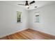 Bright bedroom with hardwood floors, ceiling fan, and windows for natural light at 1580 Youngfield St, Lakewood, CO 80215
