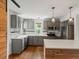 Updated kitchen featuring stainless steel appliances, quartz countertops, and subway tile backsplash at 1580 Youngfield St, Lakewood, CO 80215