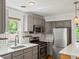 Updated kitchen with stainless appliances, quartz countertops, and subway tile backsplash at 1580 Youngfield St, Lakewood, CO 80215