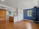 Open-concept living space with hardwood floors, wood-burning stove, and access to the modern kitchen at 1580 Youngfield St, Lakewood, CO 80215