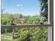 Bright window view of lush greenery, flowers, and distant mountains creates a serene and picturesque backdrop at 1580 Youngfield St, Lakewood, CO 80215