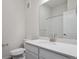 Bright bathroom with white cabinets, white countertops, a framed mirror, and a shower with glass door at 485 Interlocken Blvd # 103, Broomfield, CO 80021