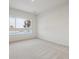 Bedroom featuring large windows with natural light and neutral carpeting at 485 Interlocken Blvd # 103, Broomfield, CO 80021