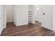 A bright, open room with wood floors, built in shelves, and white walls at 485 Interlocken Blvd # 103, Broomfield, CO 80021