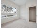Bright bedroom with plush carpeting and a large window, complemented by a convenient closet at 485 Interlocken Blvd # 103, Broomfield, CO 80021