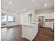 Modern kitchen with stainless steel appliances, white cabinets, and island with sink at 485 Interlocken Blvd # 103, Broomfield, CO 80021