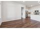 Open-concept living room leading into a modern kitchen with stainless steel appliances at 485 Interlocken Blvd # 103, Broomfield, CO 80021