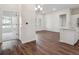 Open concept living room with modern kitchen, white walls, and a large window at 485 Interlocken Blvd # 103, Broomfield, CO 80021