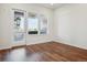 Bright living room featuring hardwood floors and a glass door to a balcony at 485 Interlocken Blvd # 103, Broomfield, CO 80021