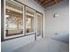 Covered patio with light gray siding, a door and 3 windows looking into a home's open kitchen at 485 Interlocken Blvd # 103, Broomfield, CO 80021