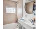 Clean bathroom with shower/tub combo and updated vanity at 4982 W Kentucky Ave, Denver, CO 80219