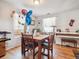 Dining area with wooden table and chairs near piano at 4982 W Kentucky Ave, Denver, CO 80219