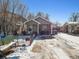 Tan house with snowy yard, black fence, and Beware of Dog sign at 4982 W Kentucky Ave, Denver, CO 80219