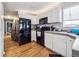 White kitchen cabinets with black appliances at 4982 W Kentucky Ave, Denver, CO 80219