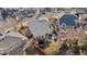 Aerial view of a fenced backyard with a patio, trampoline, and lush green lawn at 9925 Keenan St, Highlands Ranch, CO 80130