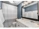 Modern bathroom featuring double sinks, updated fixtures, and a shower with stylish curtain at 9925 Keenan St, Highlands Ranch, CO 80130