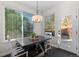 Bright dining area with natural light features stylish table, chairs, and view of the backyard at 9925 Keenan St, Highlands Ranch, CO 80130