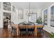 Elegant dining room with hardwood floors, a modern chandelier, and a large window at 9925 Keenan St, Highlands Ranch, CO 80130