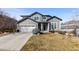 Charming two-story home with a well-manicured lawn and attached two-car garage at 9925 Keenan St, Highlands Ranch, CO 80130