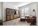 Cozy living room with a comfortable leather armchair and a wooden cabinet at 9925 Keenan St, Highlands Ranch, CO 80130