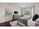 Brightly lit main bedroom featuring wooden floors, a ceiling fan, and modern decor at 9925 Keenan St, Highlands Ranch, CO 80130