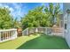 Inviting back deck with artificial turf flooring, white railing, and comfortable seating perfect for outdoor relaxation at 19075 E Grand Cir, Aurora, CO 80015